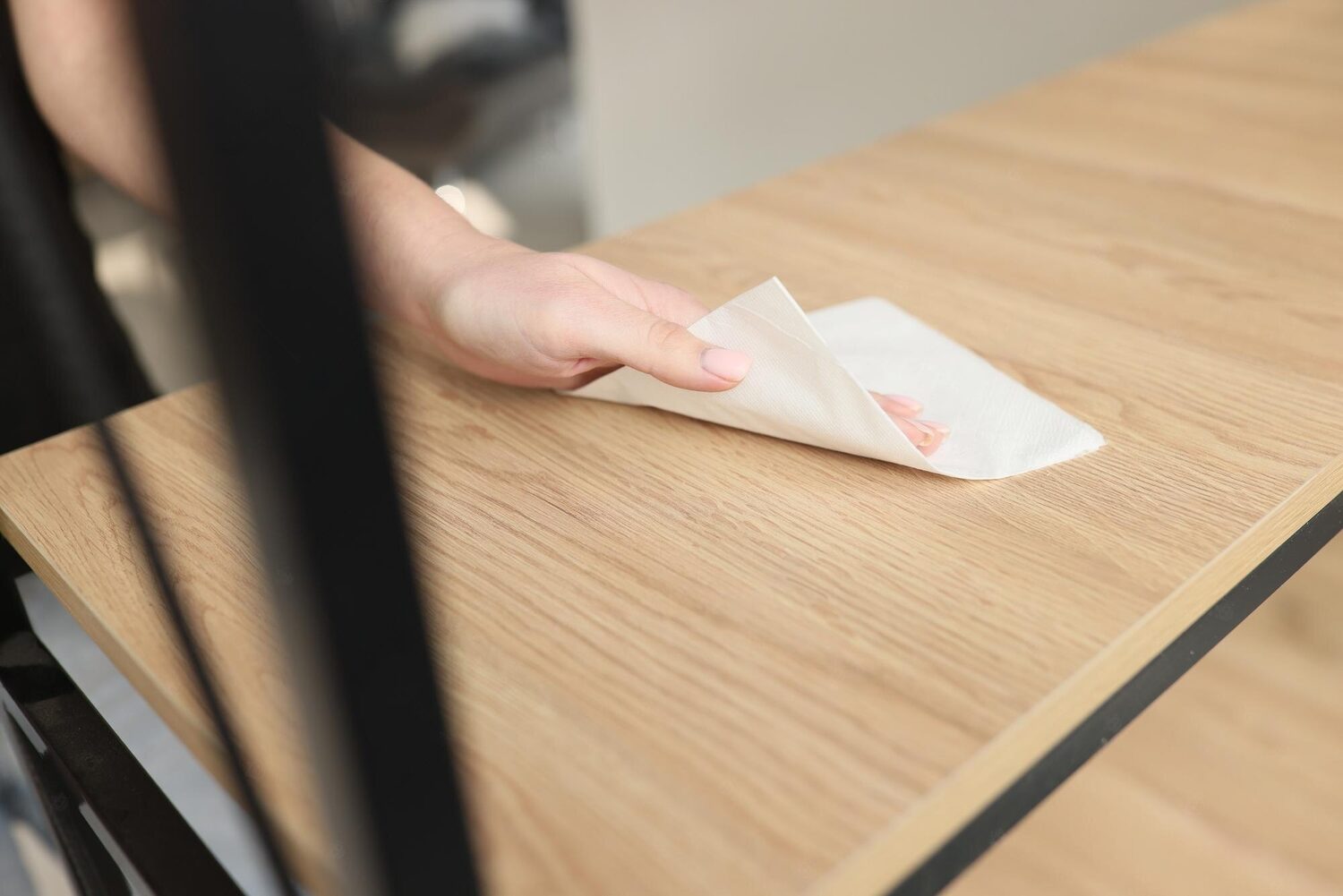 除甲醛前一個人用布擦拭木桌的圖片。